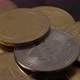 Crypto coins on black background. Hand and Bitcoin BTC Ethereum ETH on a pile of different coins - VideoHive Item for Sale