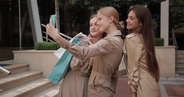 Female Friends Taking Selfies with Shopping Bags While Standing at City Street, Attractive Women alt