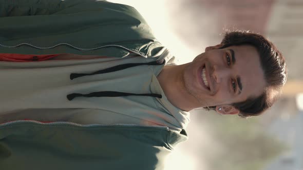 Young Guy in Stylish Wear Standing Among Smoke on Street