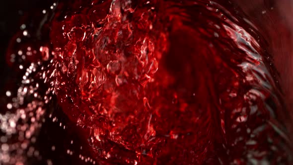 Super Slow Motion Abstract Shot of Red Wine Pouring in Glass Bottle at 1000 Fps. alt