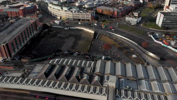 Drone shot above the city of Sheffield, panning over the Train Station, Sheffield Hallam, Park Hill alt