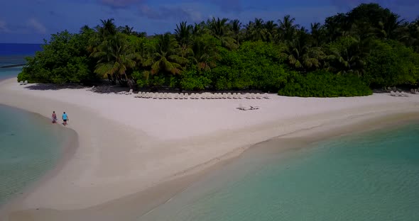 Wide angle above island view of a white sand paradise beach and blue water background  alt