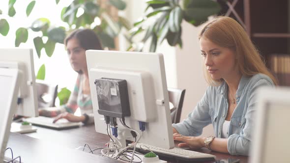 Caucasian Woman Using Personal Computer To Browse the Net in Office Library alt