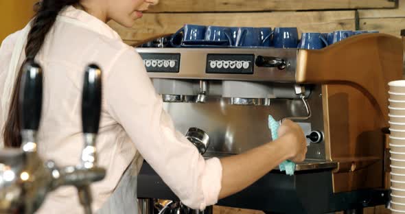 Female waitress cleaning coffeemaker in cafe 4k alt