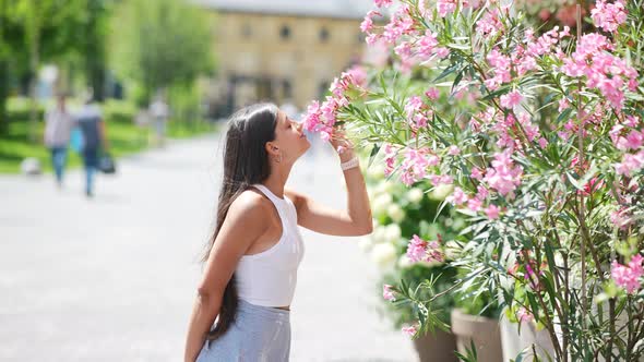 Outdoor Portrait of Young Beautiful Lady Posing Near Flowering Tree alt