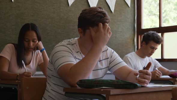 Teenagers in a school classroom alt
