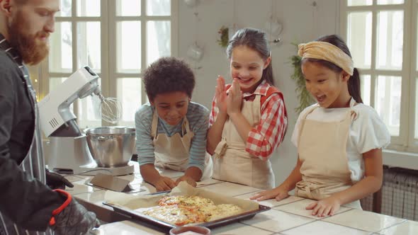 Happy Kids Enjoying Freshly Baked Pizza on Cooking Class alt