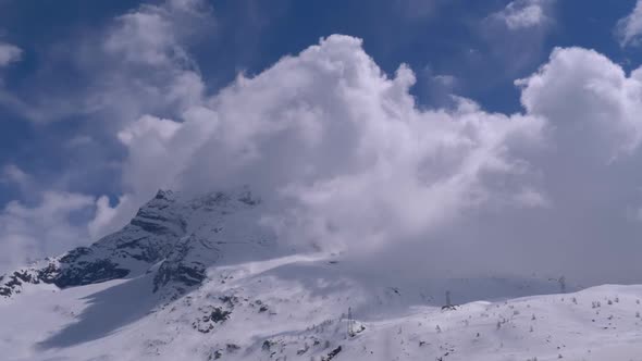 Landscape View of Alpine Mountain Snowy Peak in the Clouds. Simplon Pass alt