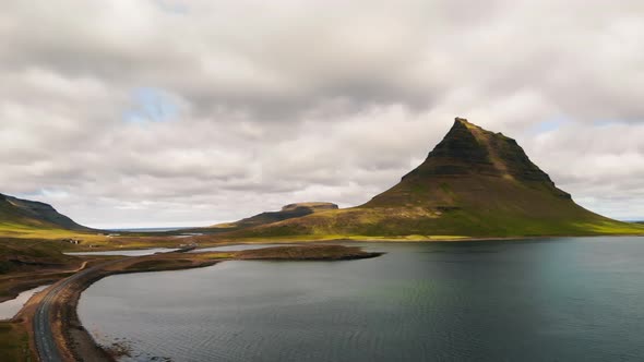 Famous Icelandic Mountain Kirkjufell with Lake and Ocean on the Background alt