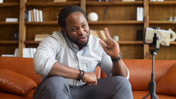 An AfricanAmerican Cheerful Guy Recording Himself with a Phone alt