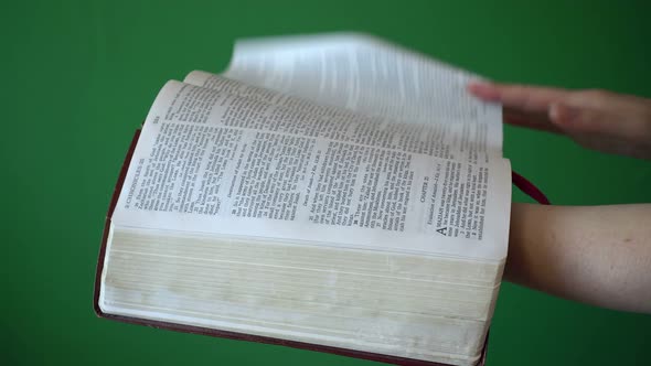 Girl Reading Bible Isolated On Chroma Key Green Screen Background alt