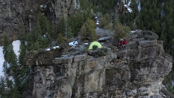 Flying towards tent on top of a cliff looking down at the campsite alt