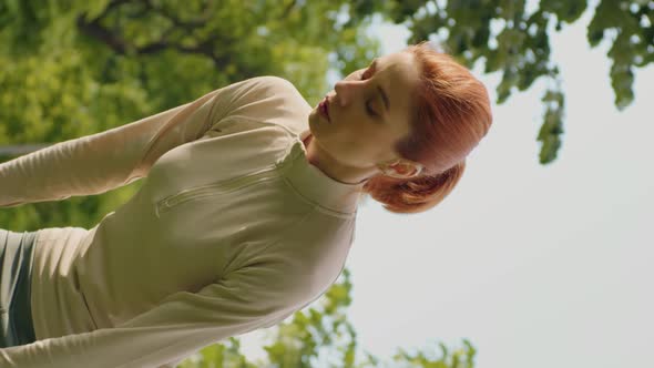 Vertical Screen Woman stops from jogging and making short break to breath. alt