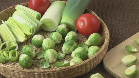 Brussels sprouts (Brassica oleracea) tomato, leek in a basket