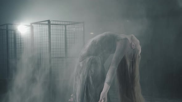 Cute Flexible Girl Raising Her Head with Flour on the Hair Making the Cloud in the Air and Puts Head alt