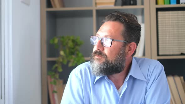 Caucasian reflexive looking at laptop screen, reflexing on work, businessman independent working