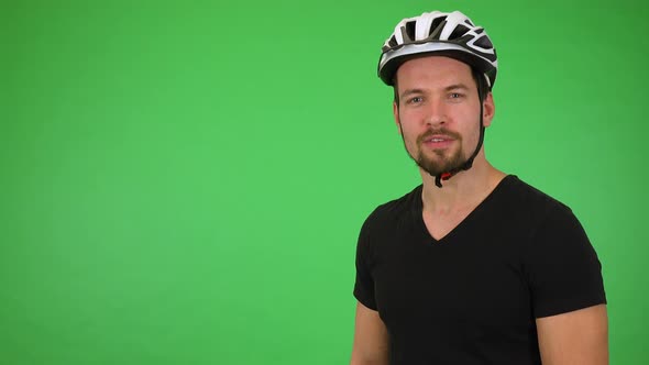 A Young Happy Cyclist Talks with Smile To the Camera - Green Screen Studio alt