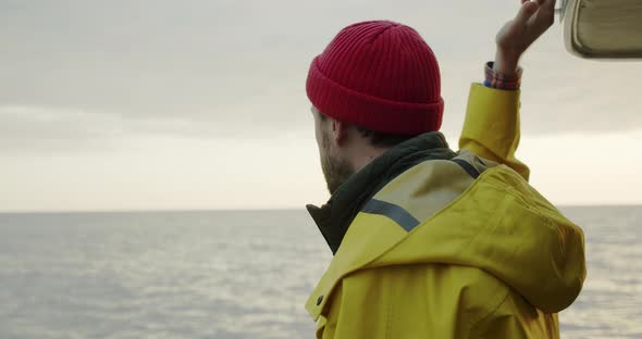 Portrait of a Smiling Sailor Sailing on a Boat at Sunset