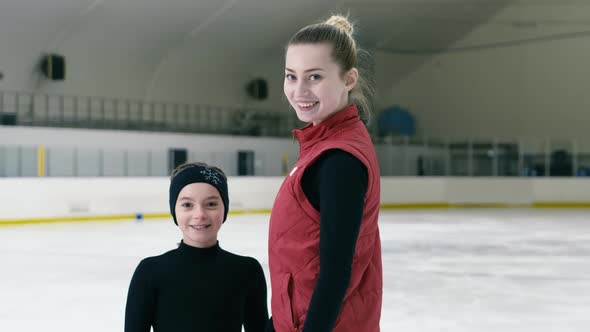 Portrait of figure skating trainer and small trainee