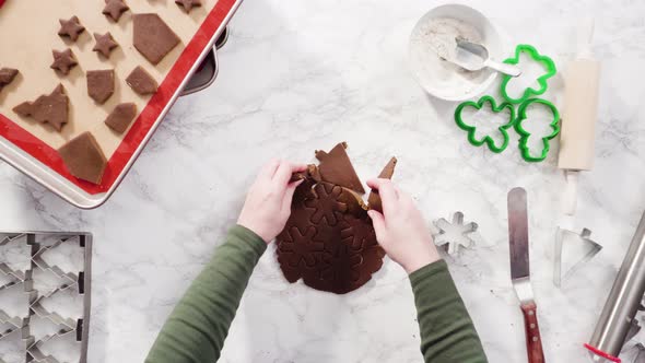 Flat lay. Step by step. Cutting out shapes with Christmas cookies cutter from gingerbread cookie dou alt