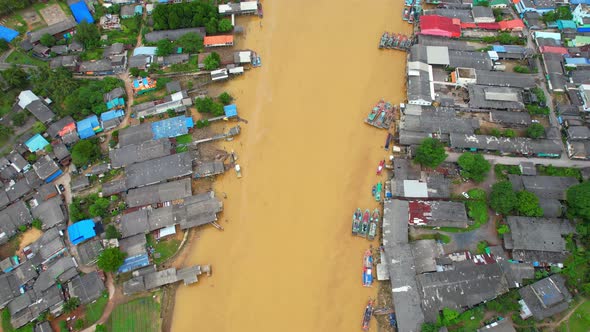 Aerial shot of river and local fisherman village beside the sea alt