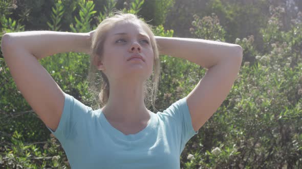 A young woman runner resting after jogging. alt