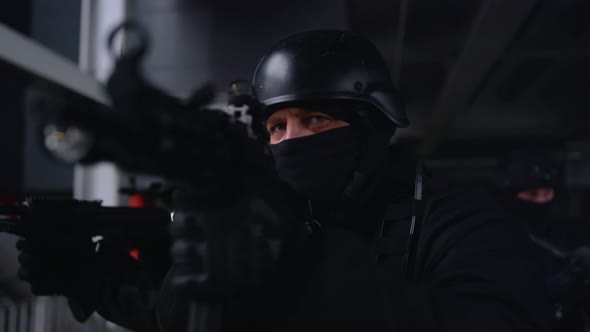 Special Forces Group in Helmets Aiming Target on Assault Rifles at Operation alt