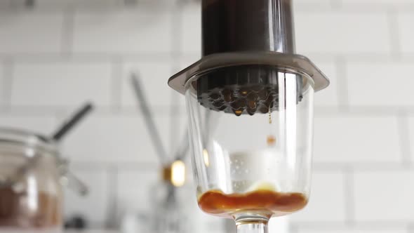 Barista Makes Aeropress Step By Step. Close Up Coffee Squeezing. Droplets. alt