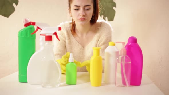 A young woman sits at a table alt