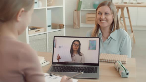 Woman Making Daughter Laugh during Distance Lesson alt