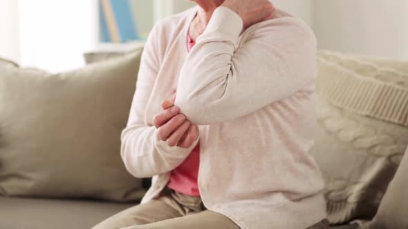Senior Woman Suffering From Pain in Hand at Home alt