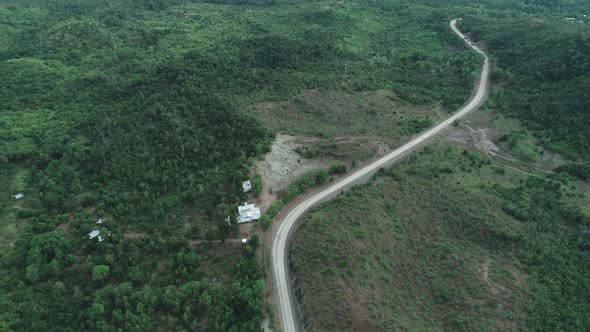 Aerial View of Countryside Road Passing Through the Lush Greenery and Foliage Tropical Rain Forest alt