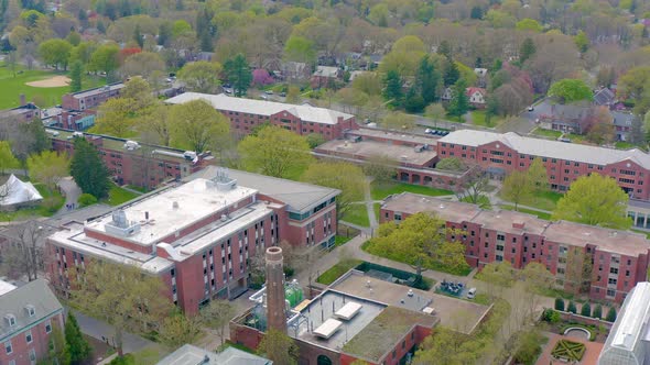 Wide aerial panorama of college housing on university campus. Large red brick buildings house studen alt