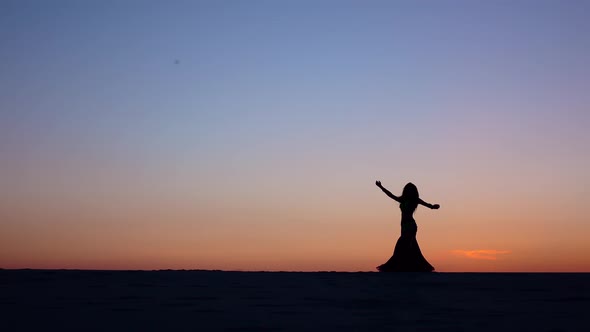 Girl Dancing Belly Dancing on the Beach Against the Sunset, Silhouettes alt