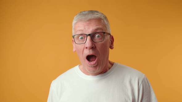 Handsome Senior Man Wearing Glasses Afraid and Shocked with Surprise Expression