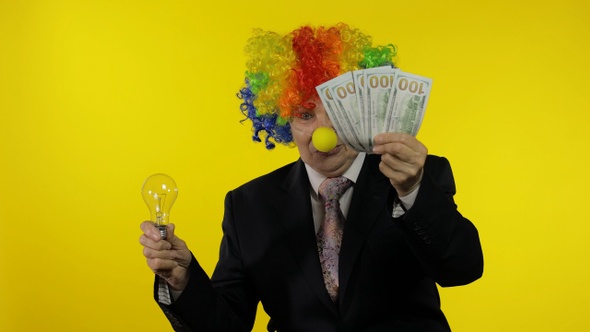 Clown Businesswoman Show Light Bulb. Came Up with Great Idea and Receive Money alt