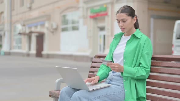 Hispanic Woman Sad for Online Shopping Failure on Laptop Outdoor alt
