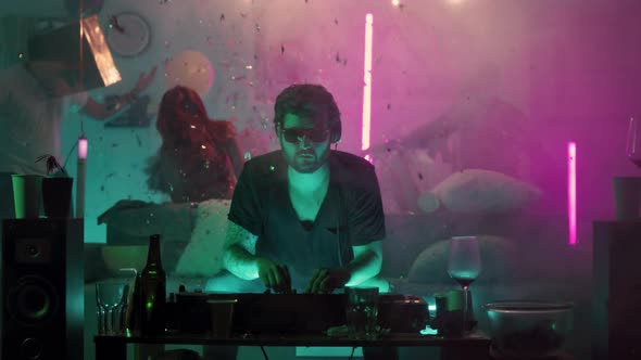 DJ Sitting on Couch During Home Party alt