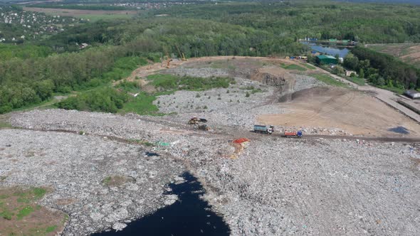 Drone Shot of Dump Trucks Working on City Landfill alt