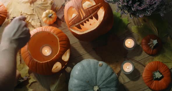 Table Top of Putting the Candles Inside the Halloween Pumpkin Head Decorations for Halloween 60p