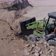 Green Construction Tractor That Loads the Stone From One Mound and Transports the Stone Elsewhere - VideoHive Item for Sale