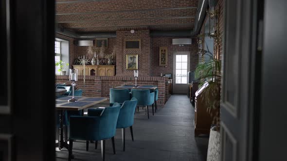 Wide Shot Interiors of Luxurious Restaurant with Joyful Interracial Couple Sitting at Table Laughing alt