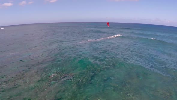 Aerial view of a man kitesurfing in Hawaii alt