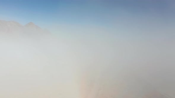 Beautiful Flight Up Through the Thick Fog Cloud at Sunrise, Desert Background alt