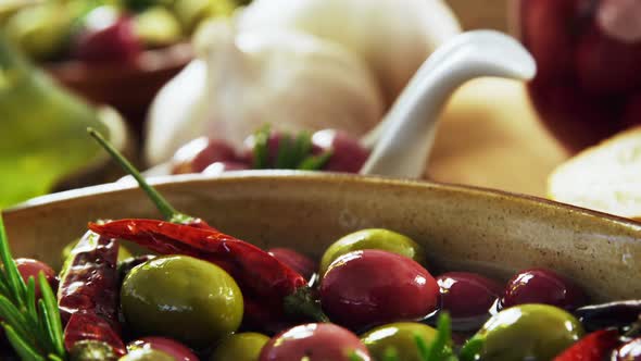 Herbs and olives in the bowl alt