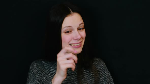 Woman Laughing To Tears Face on Black Background.