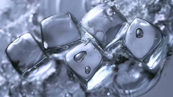 Super Slow Motion Shot of Clear Water Splashing on Ice Cubes at 1000 Fps alt