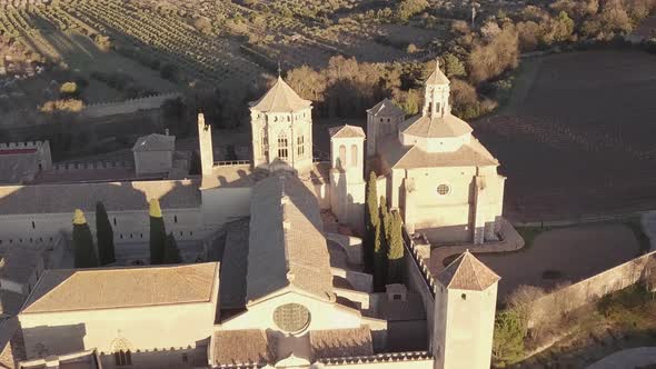 Aerial Royal Abbey of Santa Maria de Poblet Cistercian monastery At Sunset. alt
