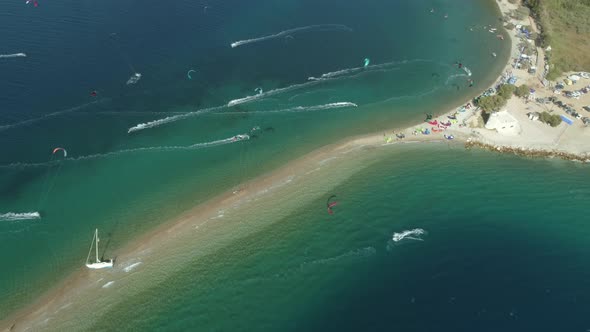 Aerial view faraway of group kitesurfing at Gulf of Patras, Greece. alt