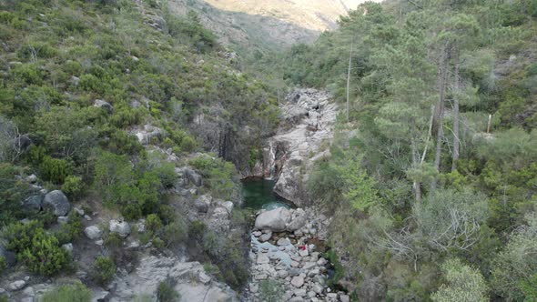 Orbital shot of rocky cascade in Portugal Geres national park, dried up river